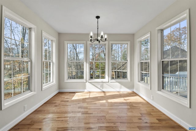 unfurnished sunroom with a chandelier