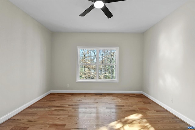 empty room with light wood-type flooring and ceiling fan