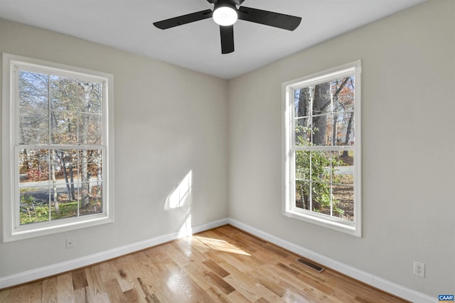 unfurnished room with ceiling fan and light wood-type flooring