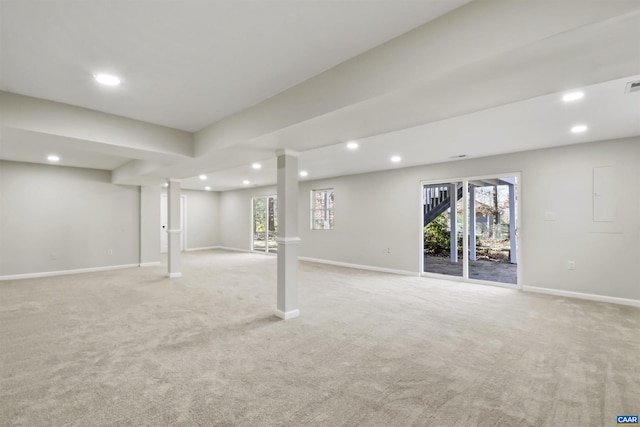 basement featuring a healthy amount of sunlight and light colored carpet