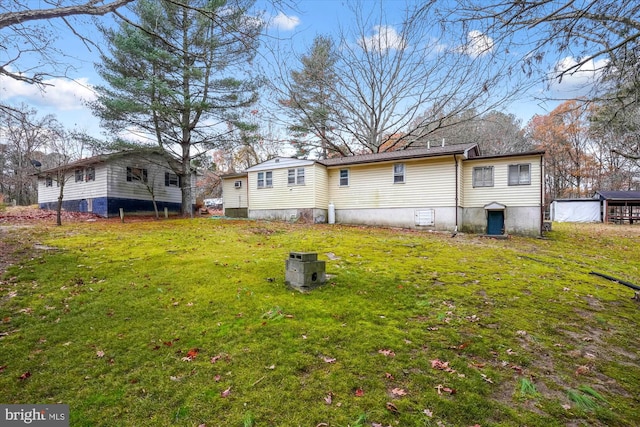 back of house featuring a lawn