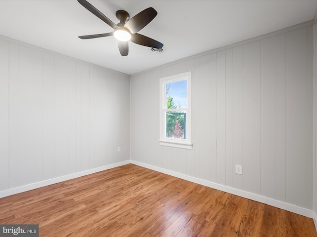 unfurnished room with hardwood / wood-style floors and ceiling fan