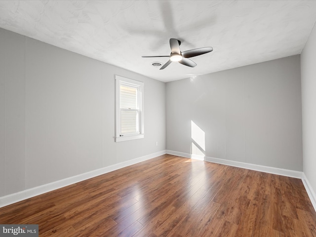 empty room featuring ceiling fan and wood-type flooring