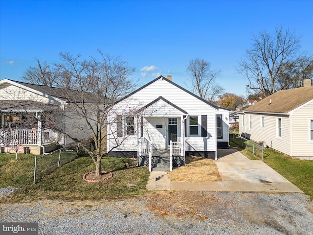 bungalow-style home with a front yard