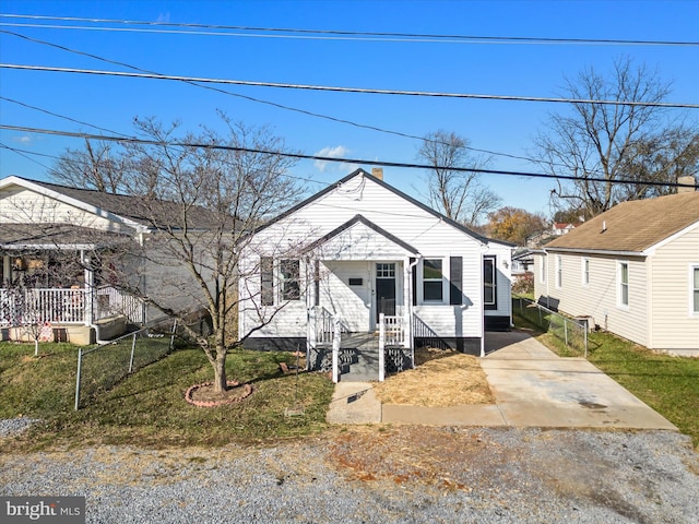 bungalow-style home featuring a front lawn