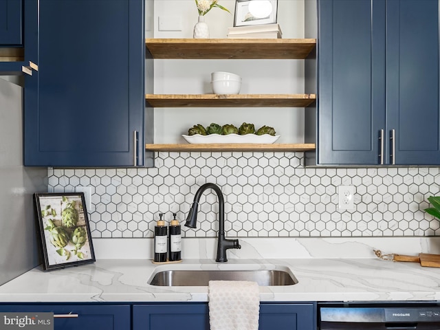 kitchen with dishwasher, sink, blue cabinetry, tasteful backsplash, and light stone counters