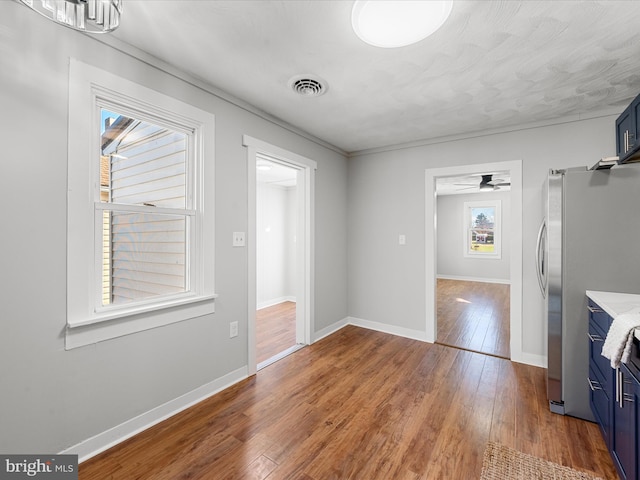 unfurnished living room featuring hardwood / wood-style floors and ceiling fan