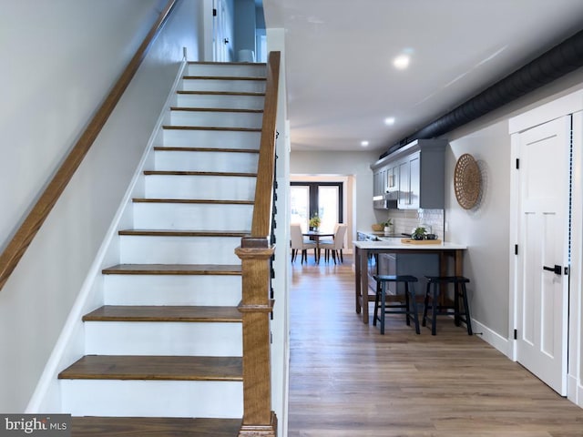 staircase featuring hardwood / wood-style floors