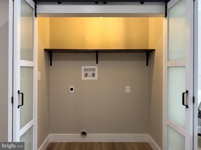 washroom featuring hookup for a washing machine, electric dryer hookup, and hardwood / wood-style floors