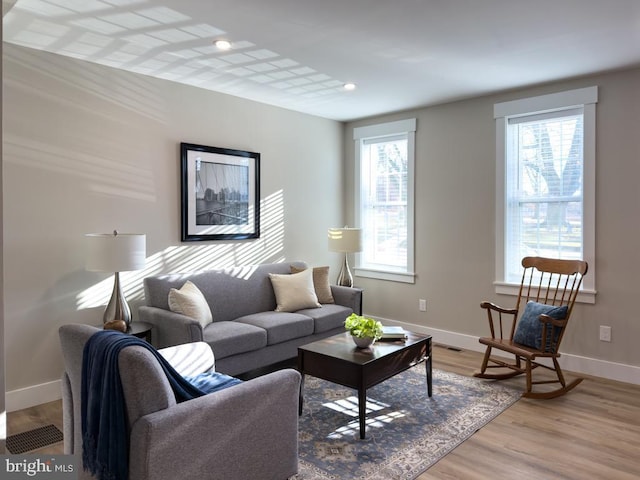 living room featuring plenty of natural light and light hardwood / wood-style floors