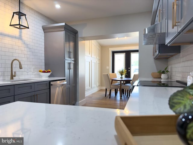 kitchen with gray cabinetry, dark wood-type flooring, sink, pendant lighting, and dishwasher