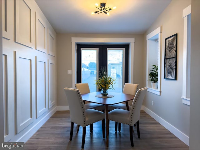 dining room with hardwood / wood-style floors and a chandelier