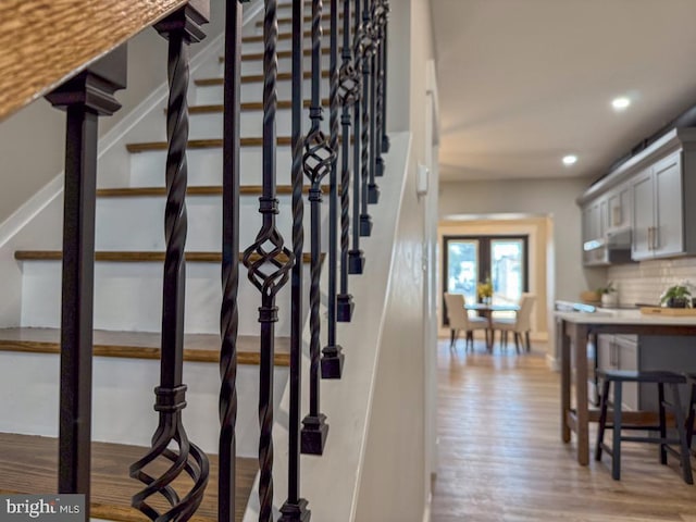 staircase with wood-type flooring