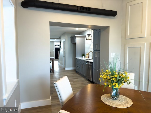 dining room featuring sink and hardwood / wood-style flooring