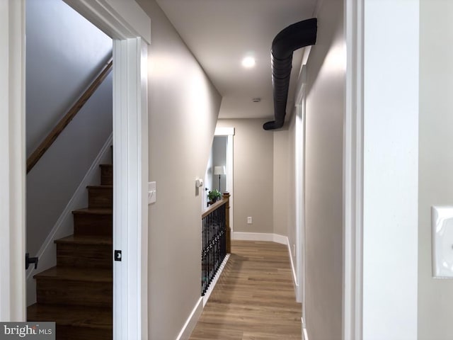 hallway with light hardwood / wood-style flooring