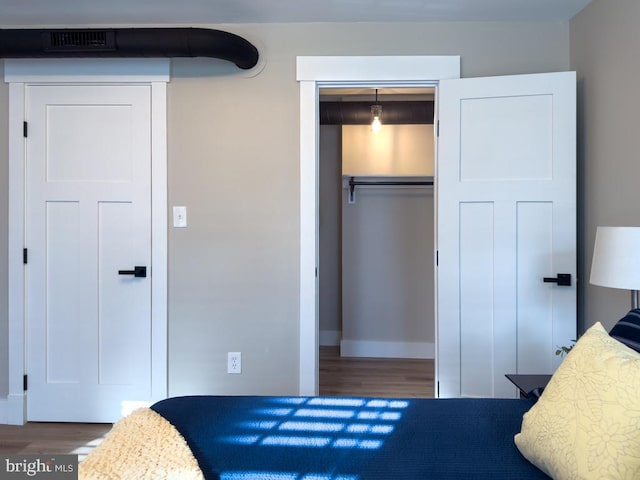 bedroom with a closet and hardwood / wood-style flooring