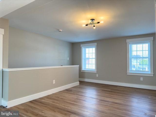 unfurnished room with wood-type flooring