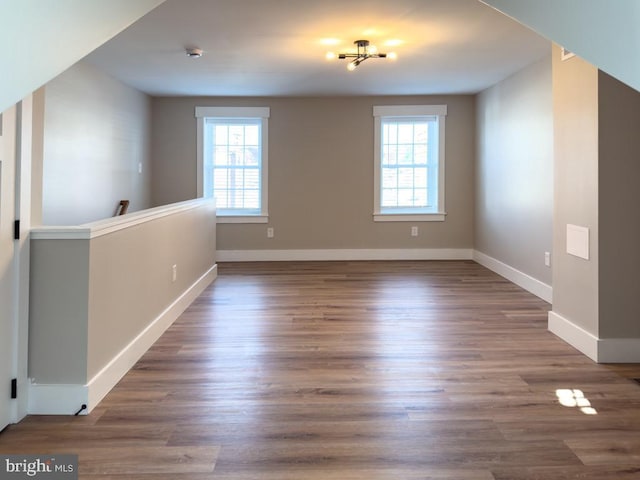 unfurnished room with a healthy amount of sunlight and dark hardwood / wood-style floors