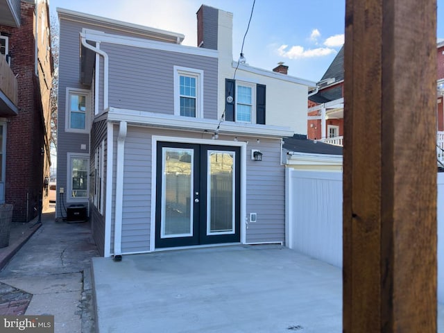 rear view of property with french doors and a patio