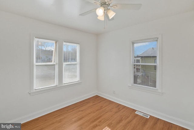 unfurnished room with hardwood / wood-style floors and ceiling fan