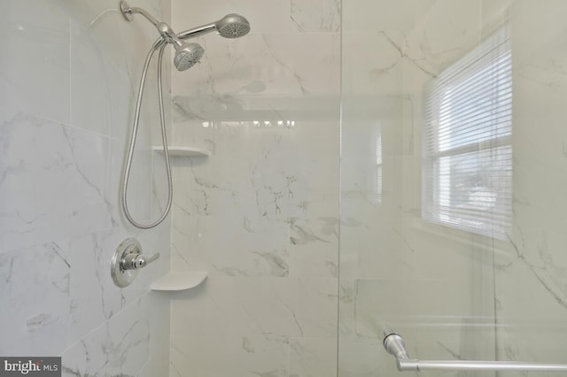 bathroom with a tile shower