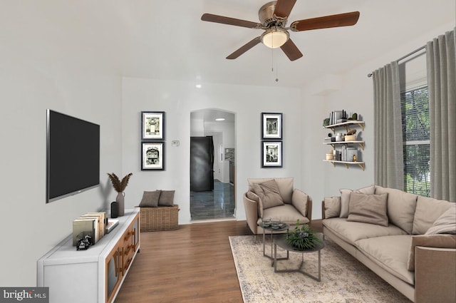 living room featuring dark hardwood / wood-style floors and ceiling fan