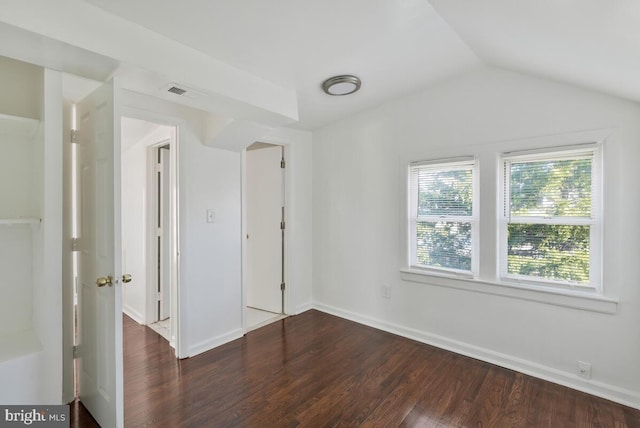 unfurnished bedroom with dark hardwood / wood-style flooring and lofted ceiling