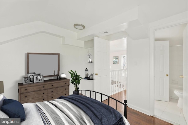 bedroom featuring wood-type flooring and connected bathroom