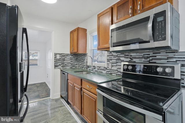 kitchen featuring tasteful backsplash, sink, and appliances with stainless steel finishes