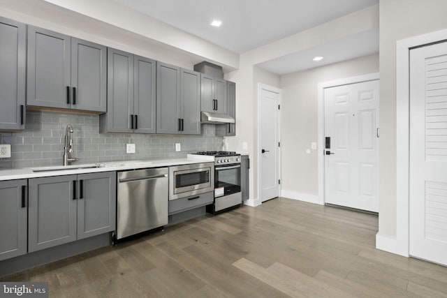 1028 Bladensburg Rd NE Unit 38, Washington, DC 20002 - kitchen with a sink, stainless steel appliances, gray cabinetry, light countertops, and tasteful backsplash