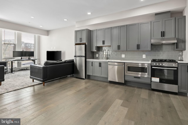 kitchen with gray cabinetry, dark hardwood / wood-style floors, and appliances with stainless steel finishes