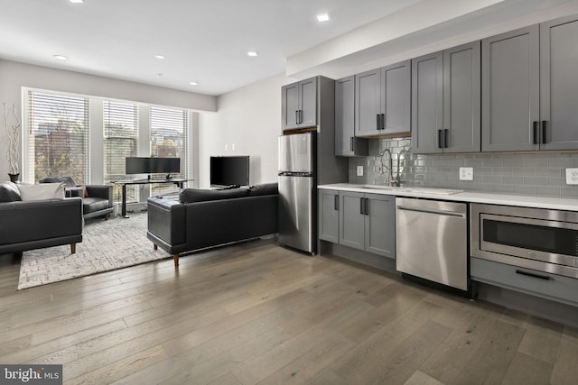 1028 Bladensburg Rd NE Unit 38, Washington, DC 20002 - kitchen featuring stainless steel appliances, a sink, gray cabinets, open floor plan, and light countertops