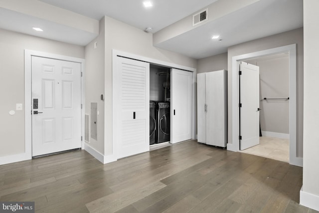 1028 Bladensburg Rd NE Unit 38, Washington, DC 20002 - unfurnished bedroom with washing machine and clothes dryer, baseboards, wood finished floors, a closet, and connected bathroom