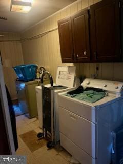 washroom featuring washing machine and dryer and cabinets