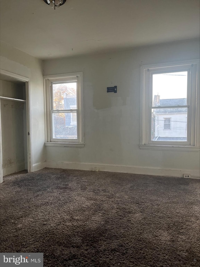 unfurnished bedroom featuring carpet flooring and a closet