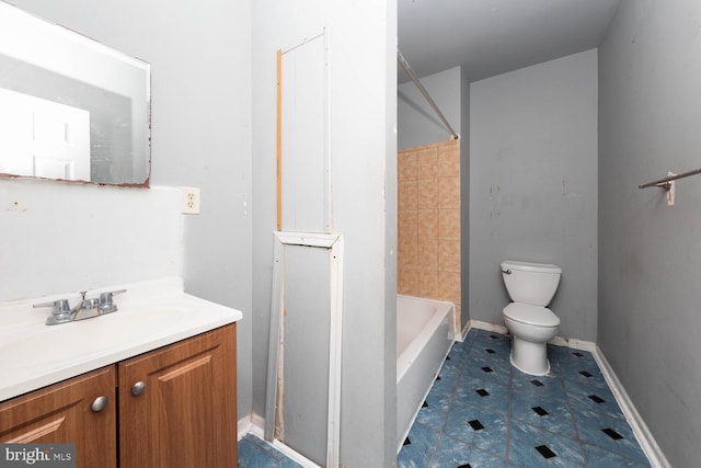 bathroom featuring tile patterned flooring, vanity, and toilet