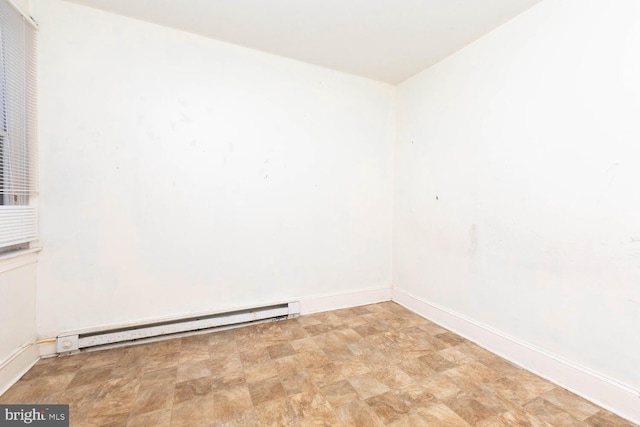 unfurnished room with a baseboard radiator