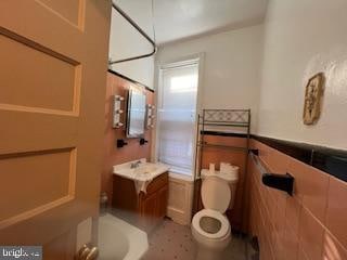 bathroom featuring vanity and toilet