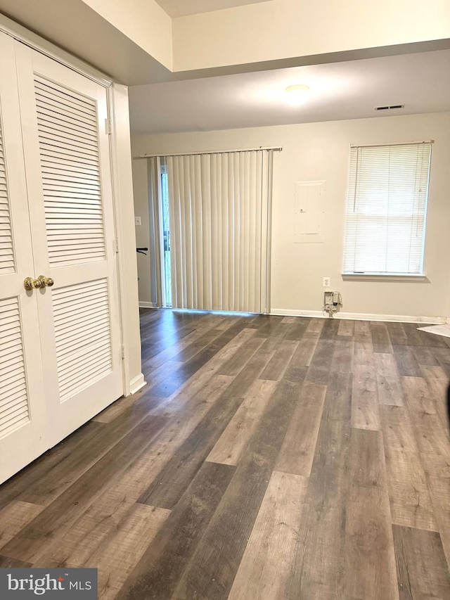 spare room with dark wood-type flooring