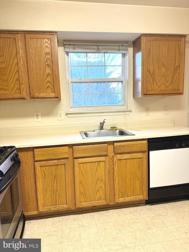 kitchen featuring dishwasher, black electric range, and sink