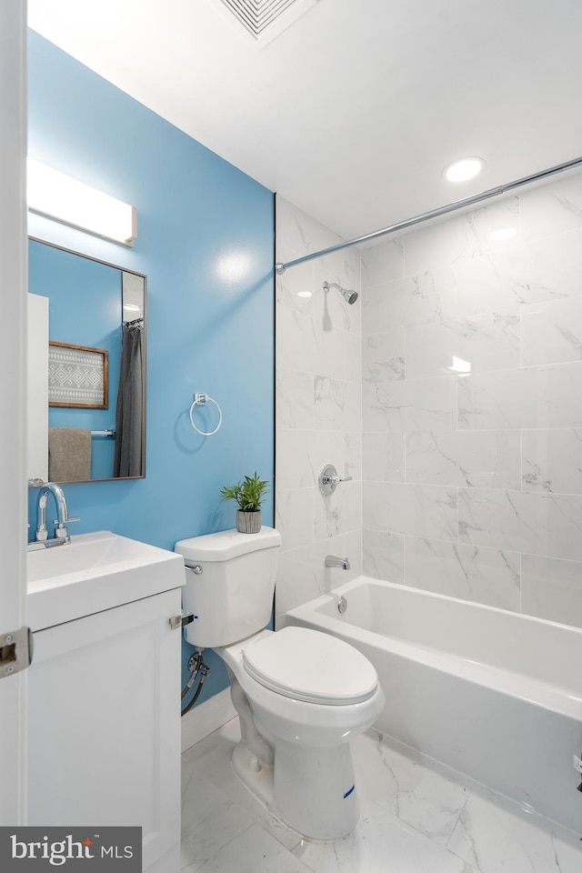 full bathroom with vanity, toilet, and tiled shower / bath