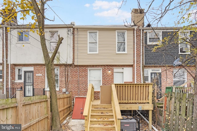 back of house featuring a deck