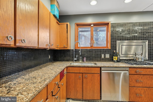 kitchen featuring decorative backsplash, sink, and stainless steel appliances