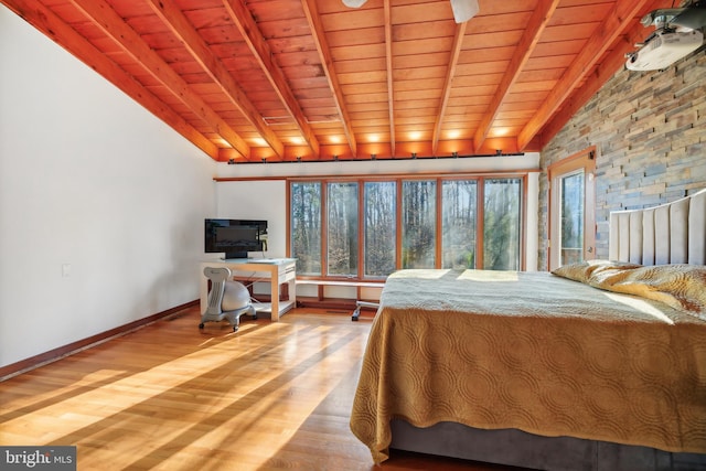 bedroom with hardwood / wood-style floors, vaulted ceiling with beams, and wooden ceiling