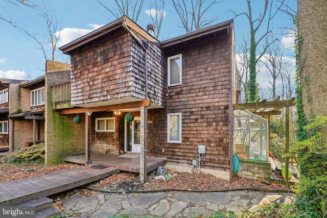 rear view of property with a balcony