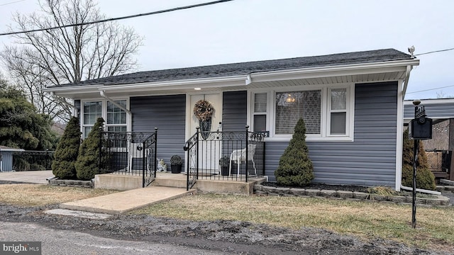 view of front of property featuring roof with shingles