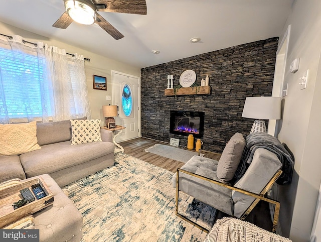 living room featuring hardwood / wood-style flooring, a fireplace, and ceiling fan