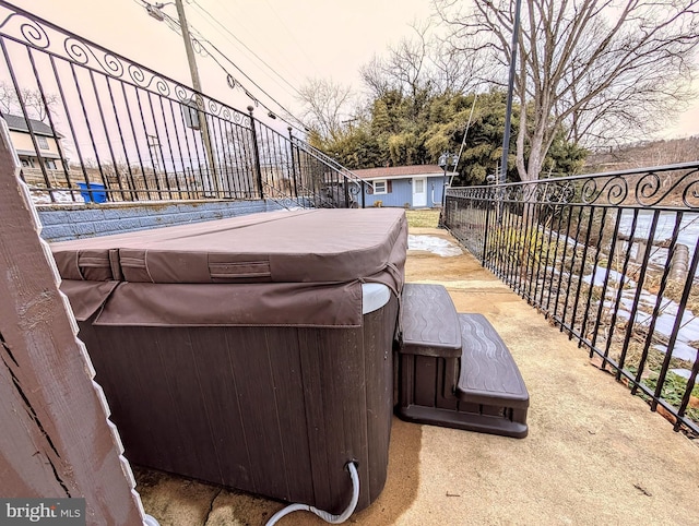 view of patio / terrace with an outdoor structure and a hot tub