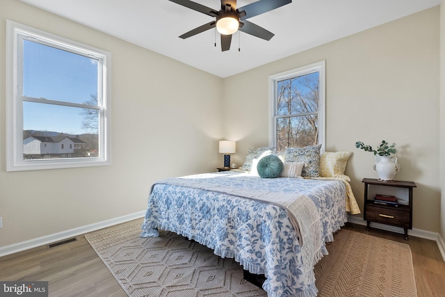 bedroom with ceiling fan and light hardwood / wood-style floors