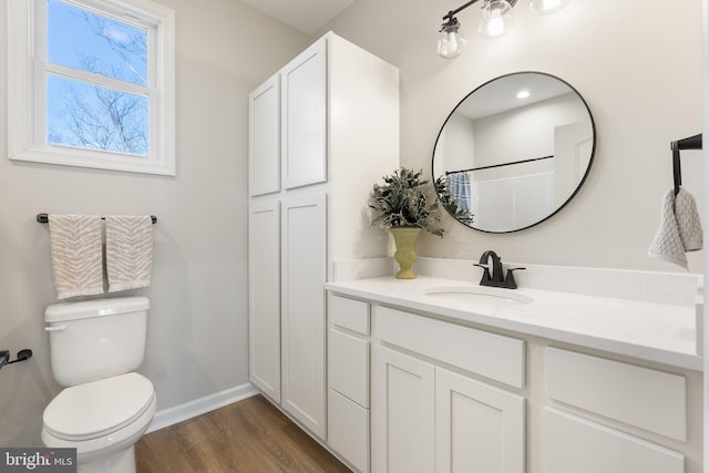 bathroom with toilet, wood-type flooring, vanity, and a shower with curtain